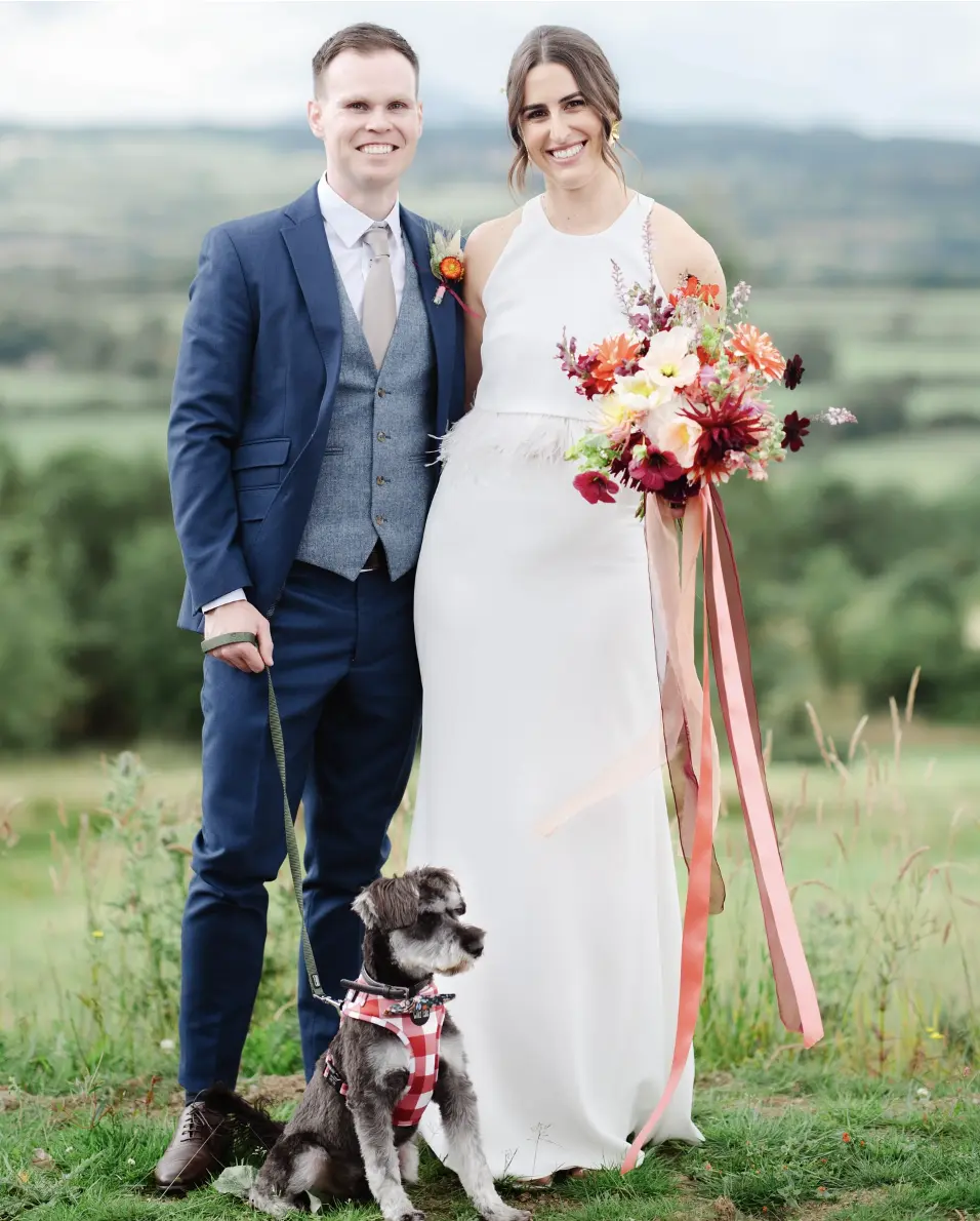 Adam & Fiona posing for wedding photos with George